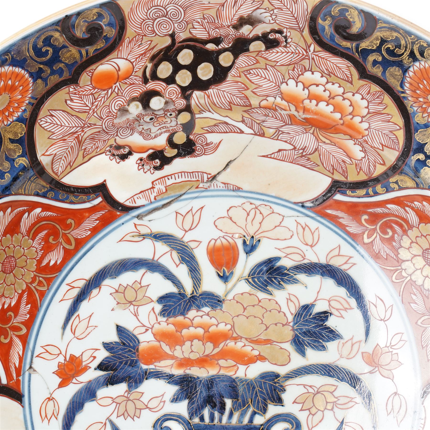 Japanese 18th century Edo period Imari porcelain charger, painted with a central peony in vase within a border of kiku and spotted shi-shi, D54cm 