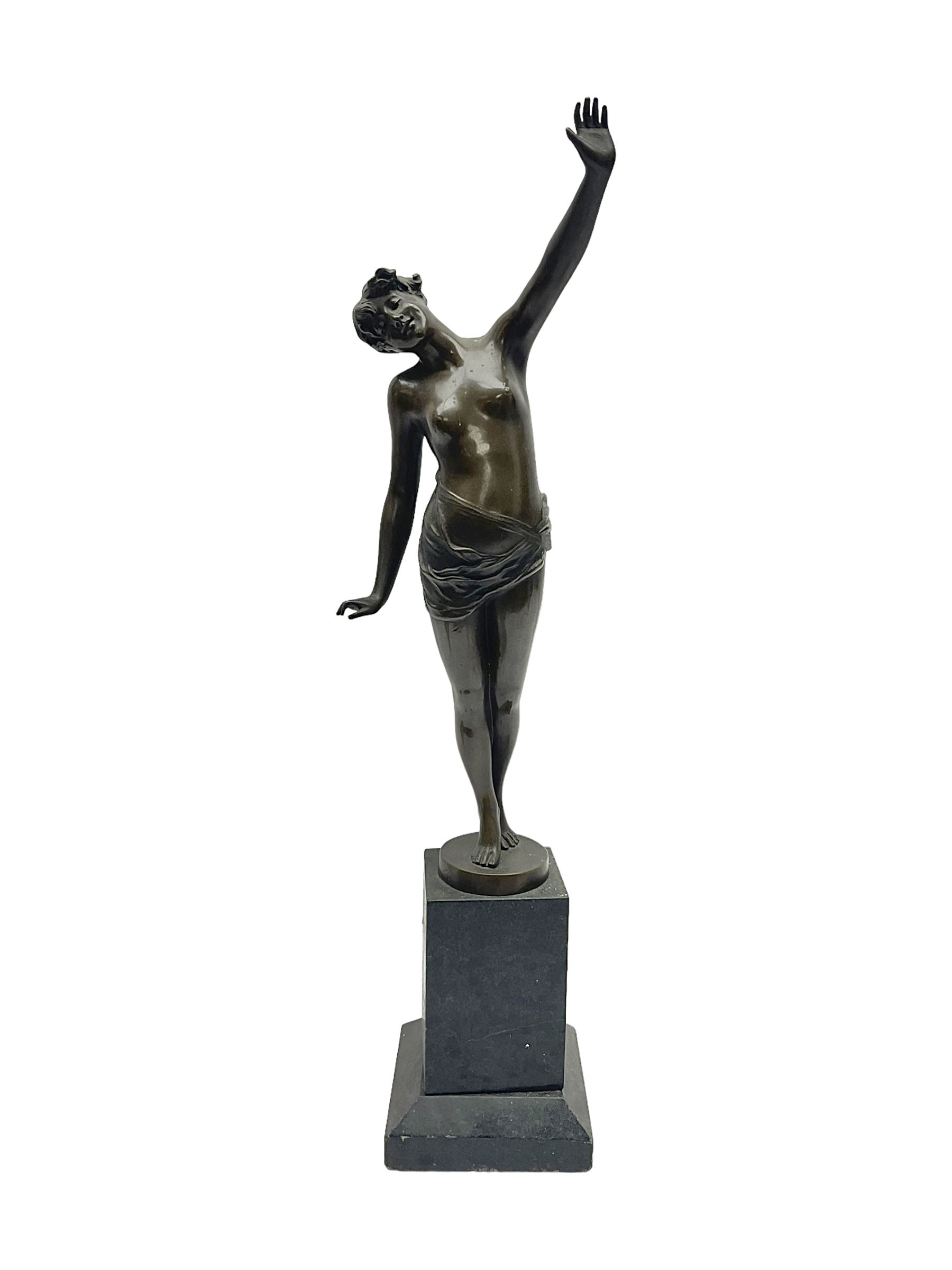 Bronzed semi nude female figure with one hand raised, upon a marble plinth, H43cm  