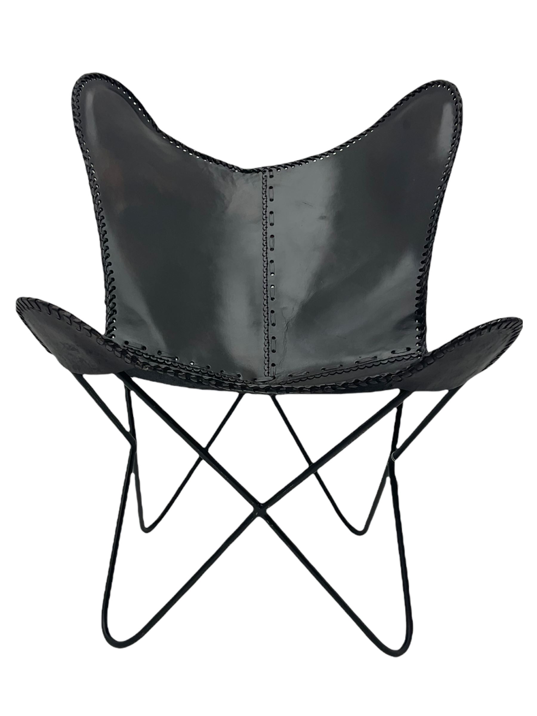 Metal framed butterfly chair upholstered in slung dark tan stitched leather 
