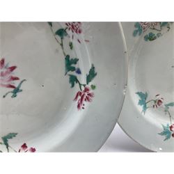 Three 18th century Chinese porcelain plates, each decorated with flowers upon a white ground, D22.5cm