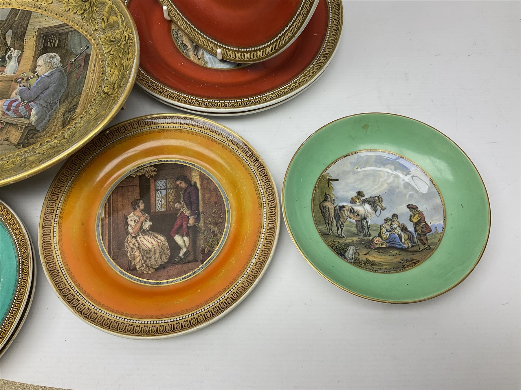 19th century Prattware table ware to include an oval footed dish decorated with a scene after Landseer 'Highland Music', retailed by James Muggleton L27.5cm, ‘The Truant’ plate after T. Webster, 'Blind Man's Buff' & 'Snap Dragon' tea plate, two side plates with malachite printed borders and others (17)