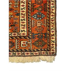 Turkish amber ground rug, the field decorated with five geometric medallions filled with contrasting segments, the guarded boarder with repeating geometric lozenges and shapes
