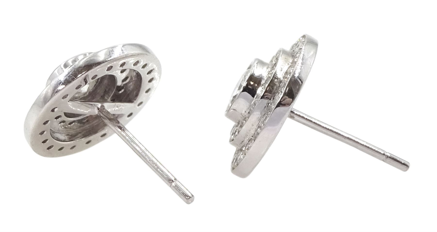 Pair of 18ct white gold round brilliant cut diamond halo stud earrings, the central bezel set diamonds with two row diamond surround, stamped, total diamond weight approx 1.20 carat