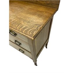 Early 20th century stripped oak chest dressing chest, fitted with two short and two long drawers, Art Nouveau handles, swing mirror back