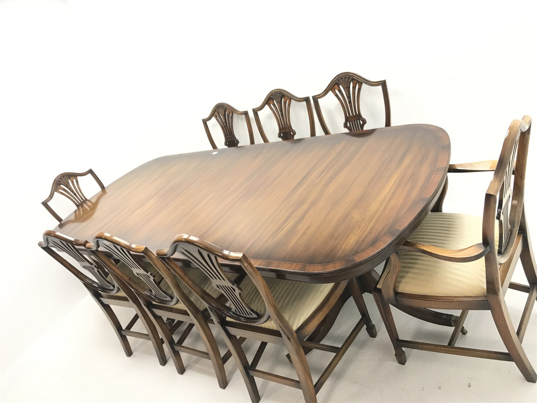 Rackstraw - Georgian style mahogany twin pedestal dining table with single leaf, turned columns on six shaped supports (W180cm and W240cm, H79cm, D104cm) and set eight (6+2) Hepplewhite style dining chairs, shaped cresting, upholstered serpentine seat, square tapering supports on spade feet (W58cm)