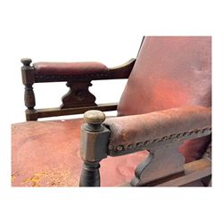 Victorian walnut framed armchair, shaped pediment carved with scrolling foliage, upholstered in leather, on ring turned front feet