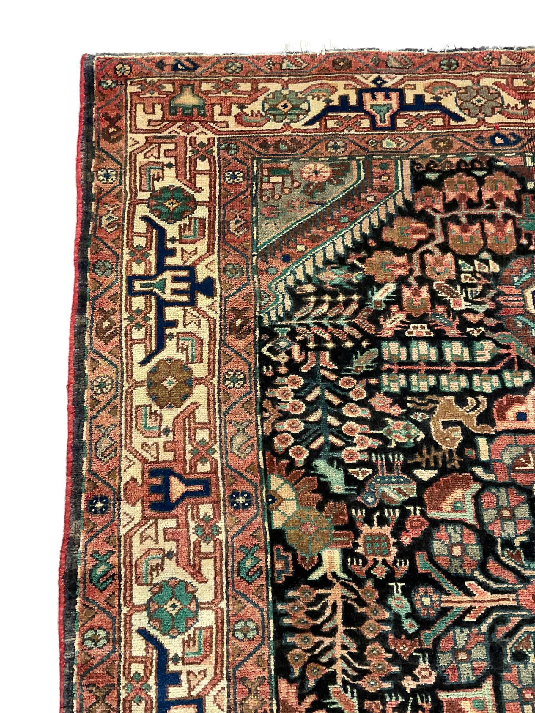 Persian Malayer rug, the field decorated with tree of life, floral, animal and bird motifs, surrounded by three band border with geometric design