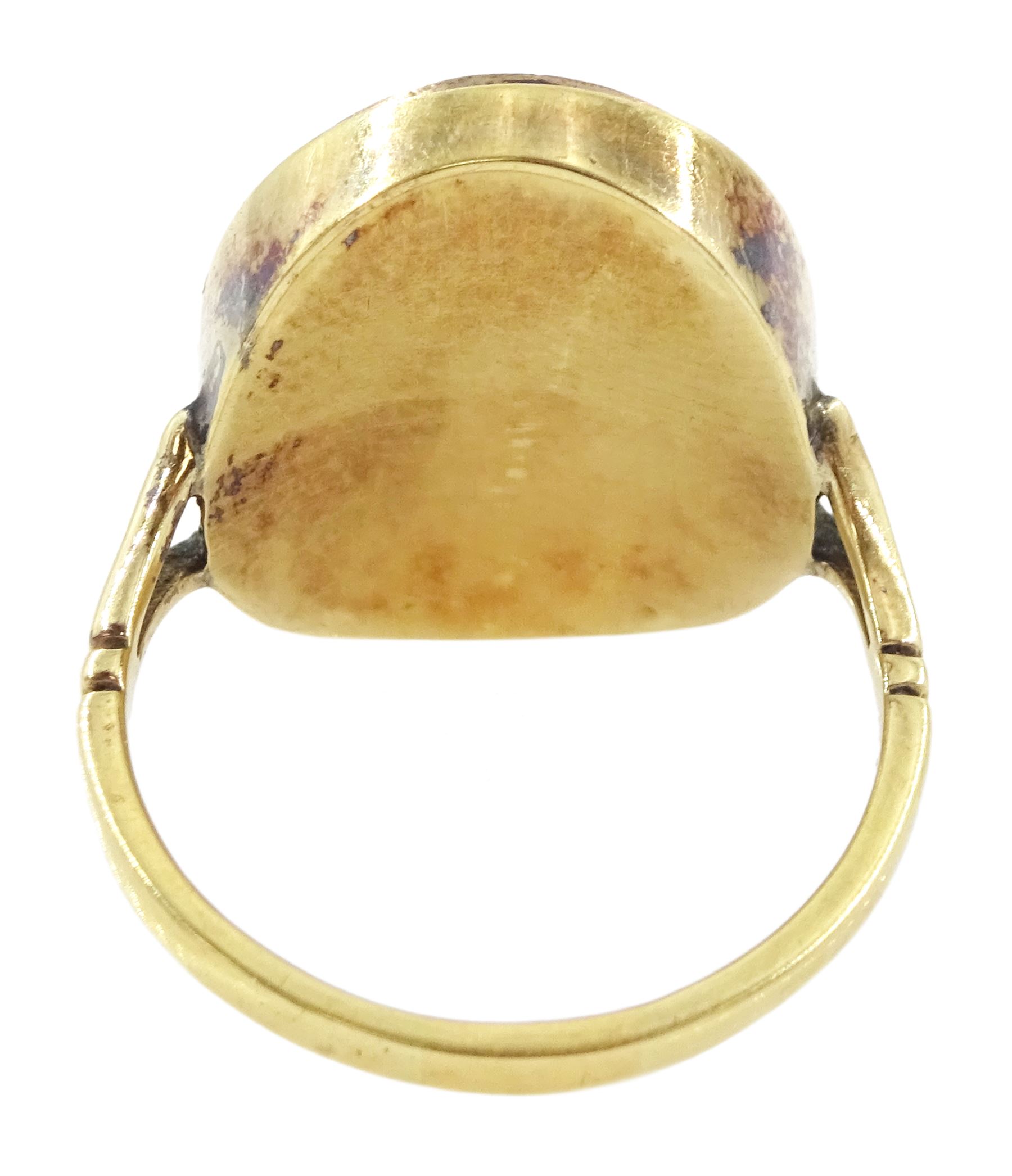 19th century gold portrait ring, set with an oval miniature of a woman wearing a pearl hairpin and earrings on ivory, under a glazed panel, set into a later gold ring with split shoulders. This lot has been registered for sale under Section 10 of the APHA Ivory Act