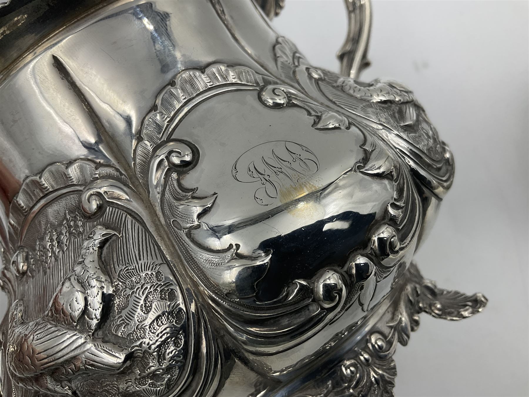 Victorian silver three piece tea service, comprising teapot, twin handled open sucrier, and milk jug, each of bellied form with acanthus capped scroll handles, the sides embossed with alternating scroll edged vacant panels and panels containing a pair of birds, upon four palmette feet, the teapot with ivory insulators to handle, and bird finial to the hinged domed cover, hallmarked William Hunter & Son, London 1861, teapot H19cm, including handles sucrier H13.5cm, including handle milk jug H12cm

This item has been registered for sale under Section 10 of the APHA Ivory Act