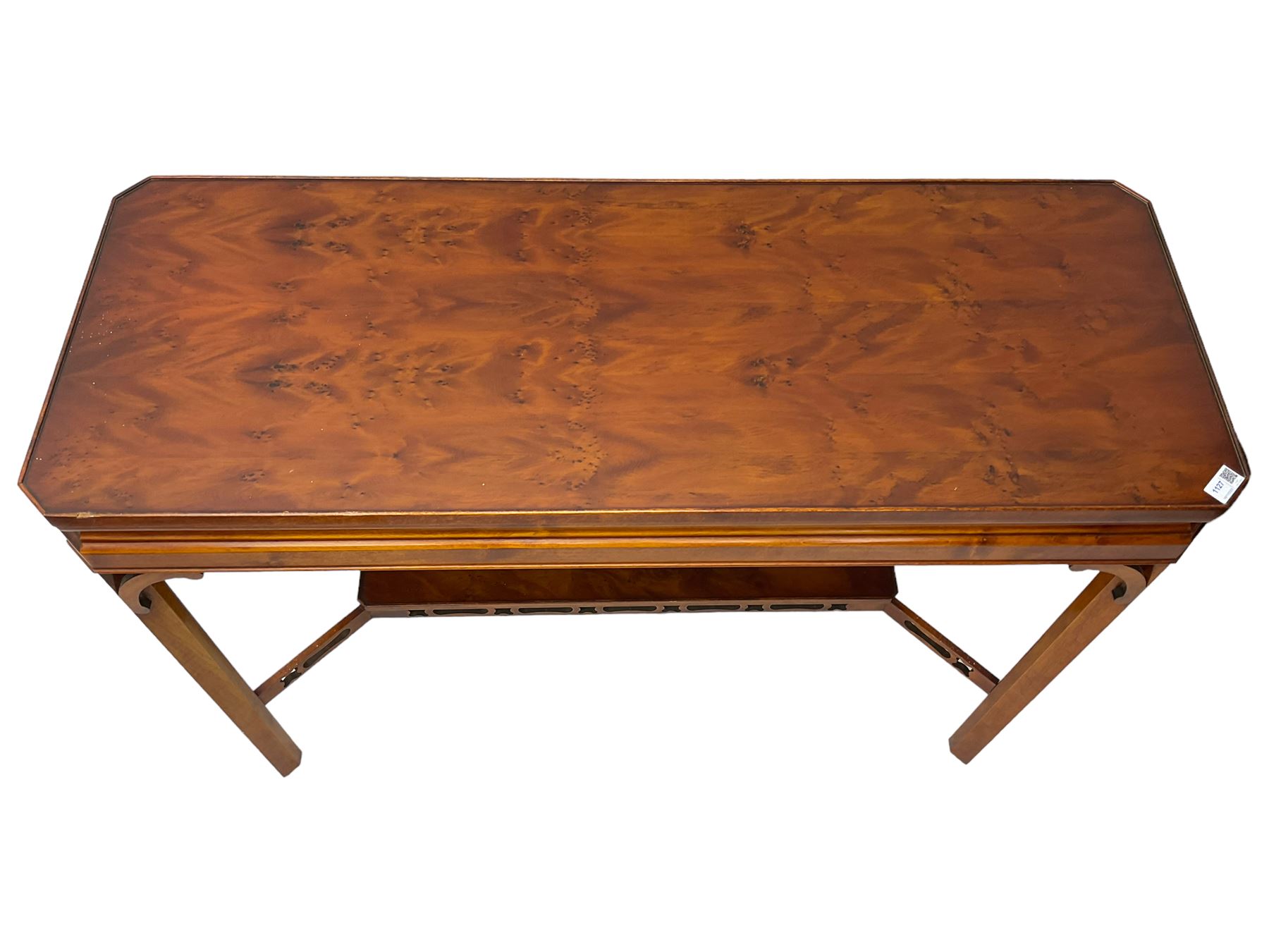Wade - yew wood console table, rectangular top with canted corners and raised lipped edge, on chamfered square supports united by narrow under-tier