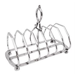 Late Victorian silver seven bar toast track, with curved and angular bars, and central stylised ring handle, upon four faceted bun feet, hallmarked Martin, Hall & Co, Sheffield 1894, approximate weight 9.35 ozt (290.9 grams)