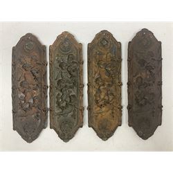 Set of four Victorian Elkington & Co copper door plates, each of shaped rectangular form, cast with putti in flight supporting a rose garland, between two mask roundels, and contained within a foliate border, with lozenge shaped mark verso detailed Elkington 1570, the facias impressed with registered diamond mark dated 8th June 1866, H31cm W10cm