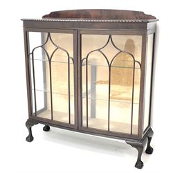 Early 20th century mahogany bow front display cabinet, raised shaped back, two doors enclosing two lined shelves, cabriole legs on ball and claw feet