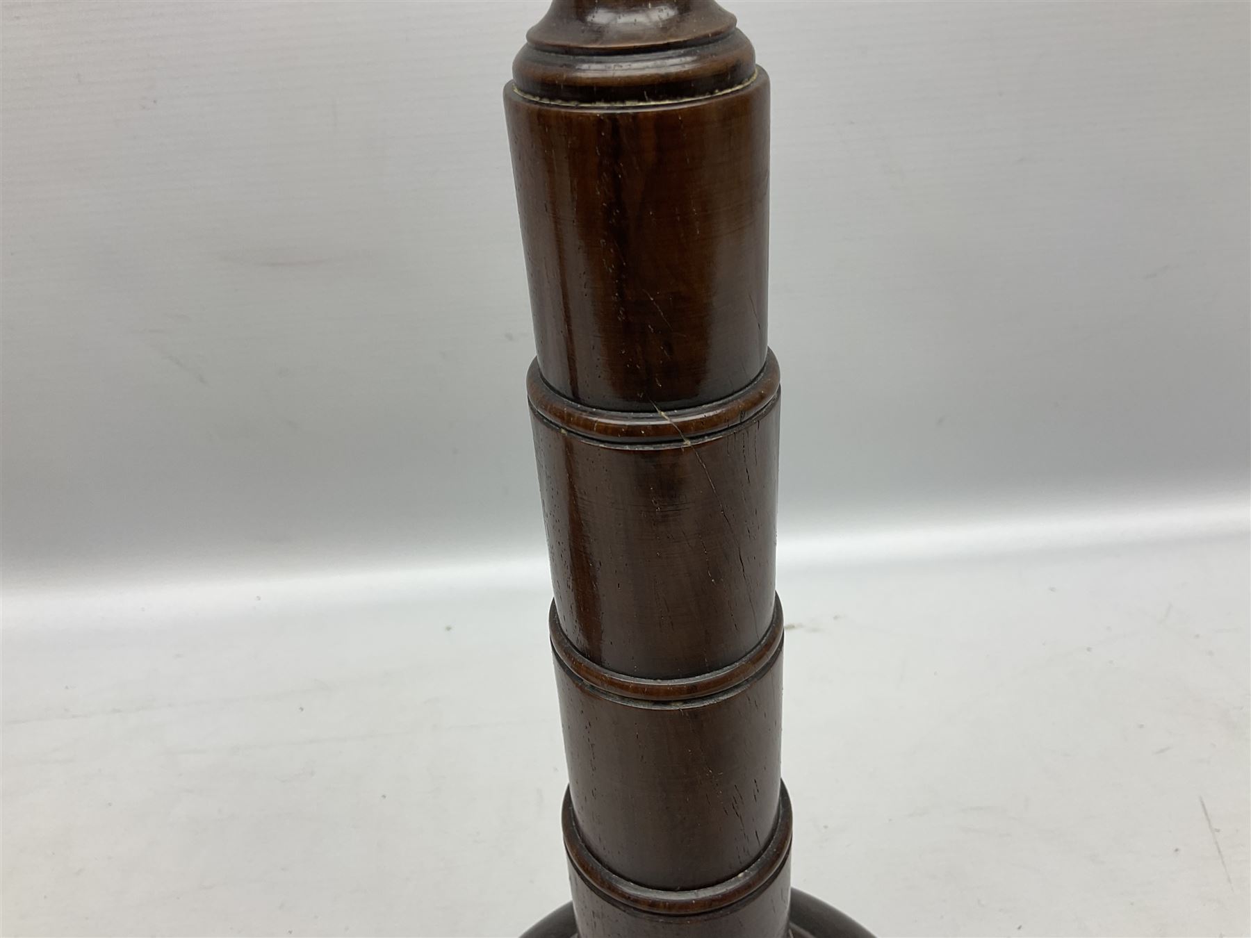 Pair of turned wooden candlesticks, the central column of stepped form raised upon circular spreading base, with drip trays, H56cm