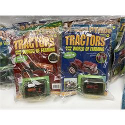 Eighteen issues of Tractors and The World of Farming magazine, together with sixty diecast tractors, all in original packaging, in three boxes 