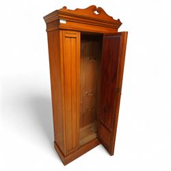 Early 20th century satin walnut wardrobe and dressing table, including a tall single wardrobe with mirrored door beneath a shaped cornice and moulded pediment, (H 205cm, D 39cm, W 91cm) and a matching dressing chest with glazed lift-top compartment and three drawers, mirror supported by scrolled uprights with flanking open shelves (H 170cm, D 45cm, W 84cm)