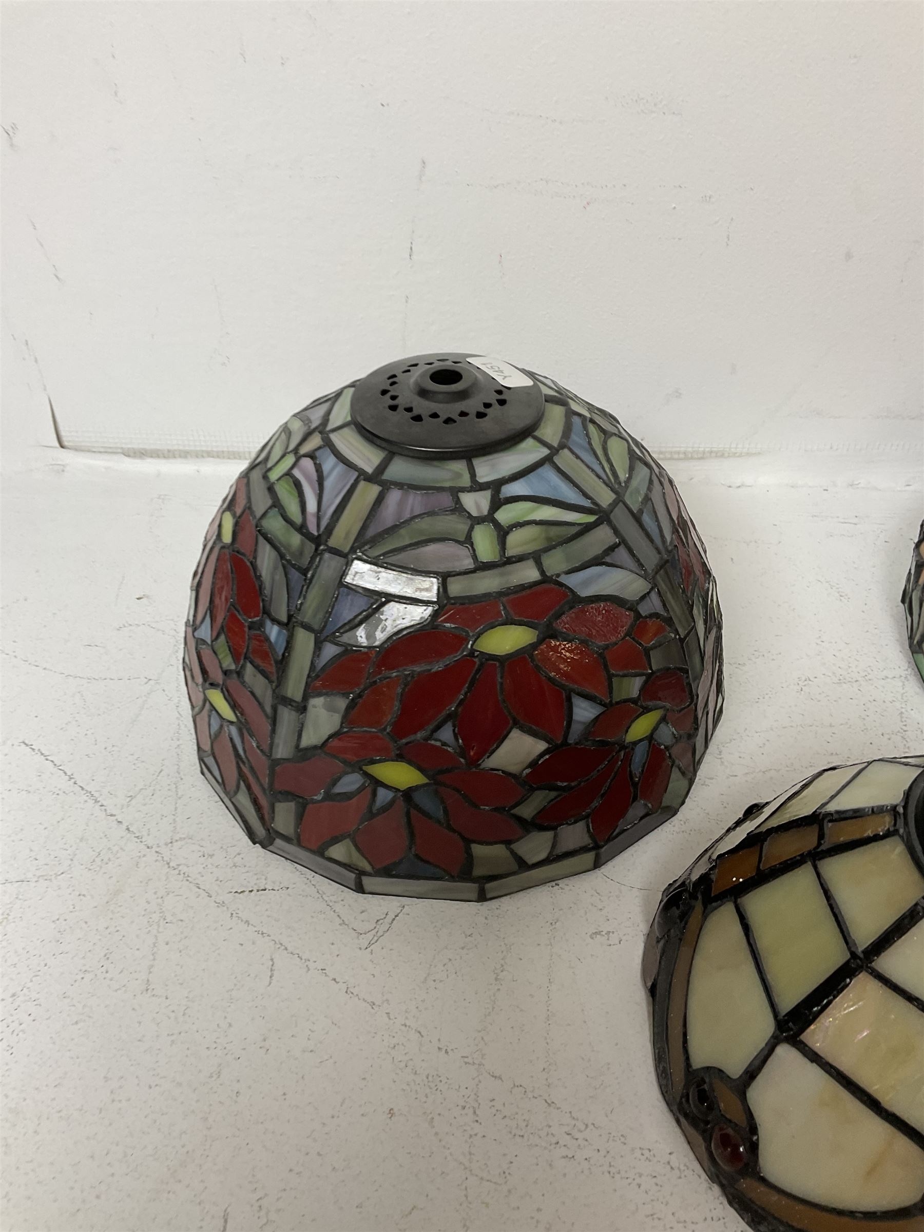 Three Tiffany style lamp shades, each with multicoloured floral decoration, largest D20.5cm