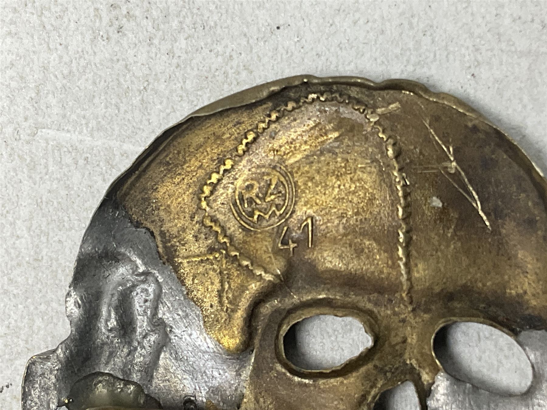 Two WW2 German 'SS' visor cap skull badges and another later; and visor cap eagle insignia (4)