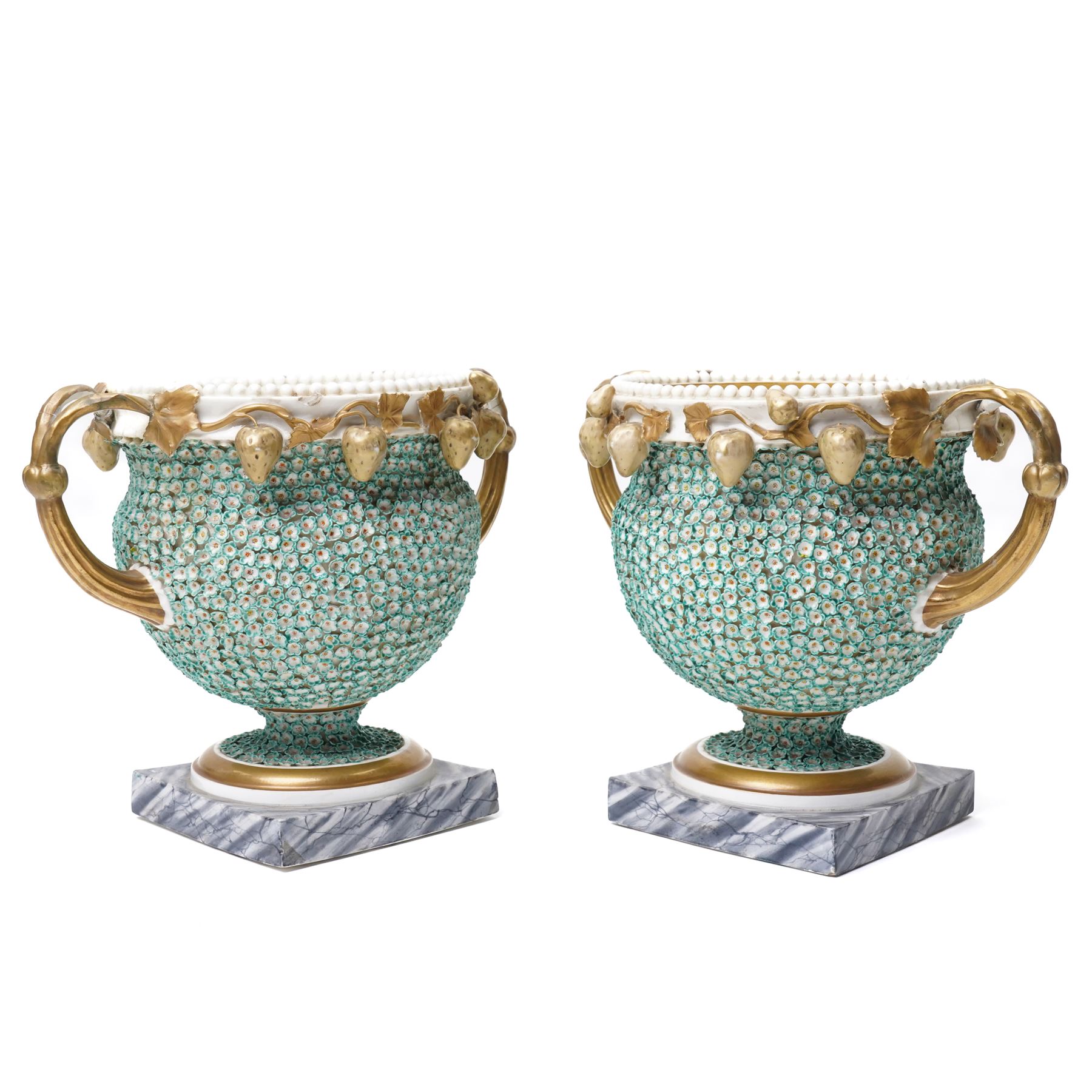Pair of 19th century Grainger Lee & Co Worcester urns, c1820s-1830s, hand-painted with views of 'Near London Bridge' and 'Brighton Pavilion' upon a ground of encrusted forget-me-not decoration, the beaded rim with twin naturalistically formed handles, leading into vines moulded with strawberries in high relief, the pedestal painted to imitate marble, painted marks to base, H20cm