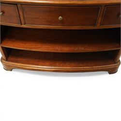 Willis & Gambier - curved sideboard, curved rectangular top, above three frieze drawers with brass pulls over two open recesses, on bracket feet 