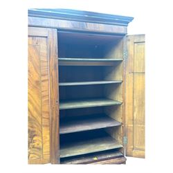 Early 19th century mahogany linen press cupboard, projecting moulded cornice over figured frieze, two panelled doors enclosing shelves, fitted with two short and two long cock-beaded drawers, on bracket feet 