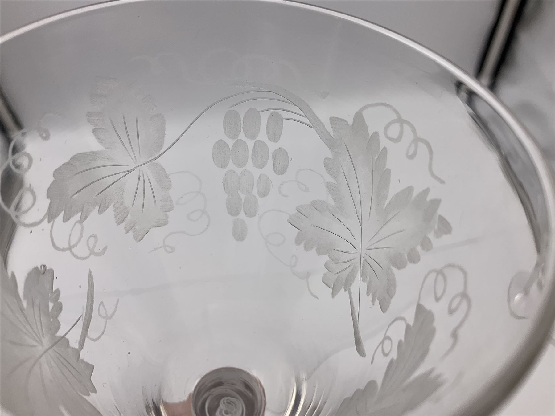 Set of three 18th century style wine glasses, each with funnel bowl etched with fruit vine, upon a double series air twist stem and circular foot, H17cm