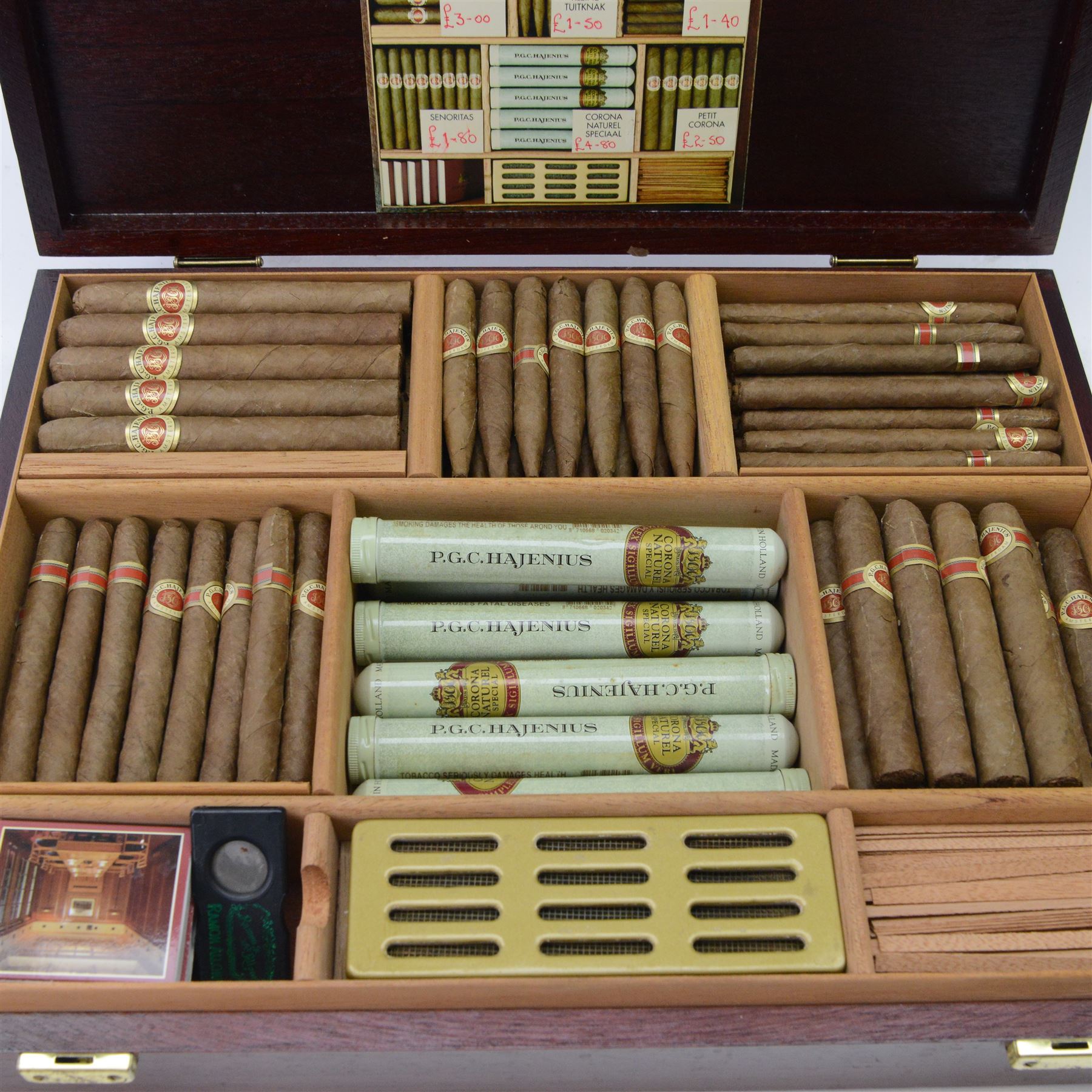P.G.C. Hajenius of Amsterdam mahogany humidor, containing various loose Hajenius cigars, including Corona, Corona Naturel Special, Klieine Tuitnak, with matches and cigar cutter, D30cm, L38cm   