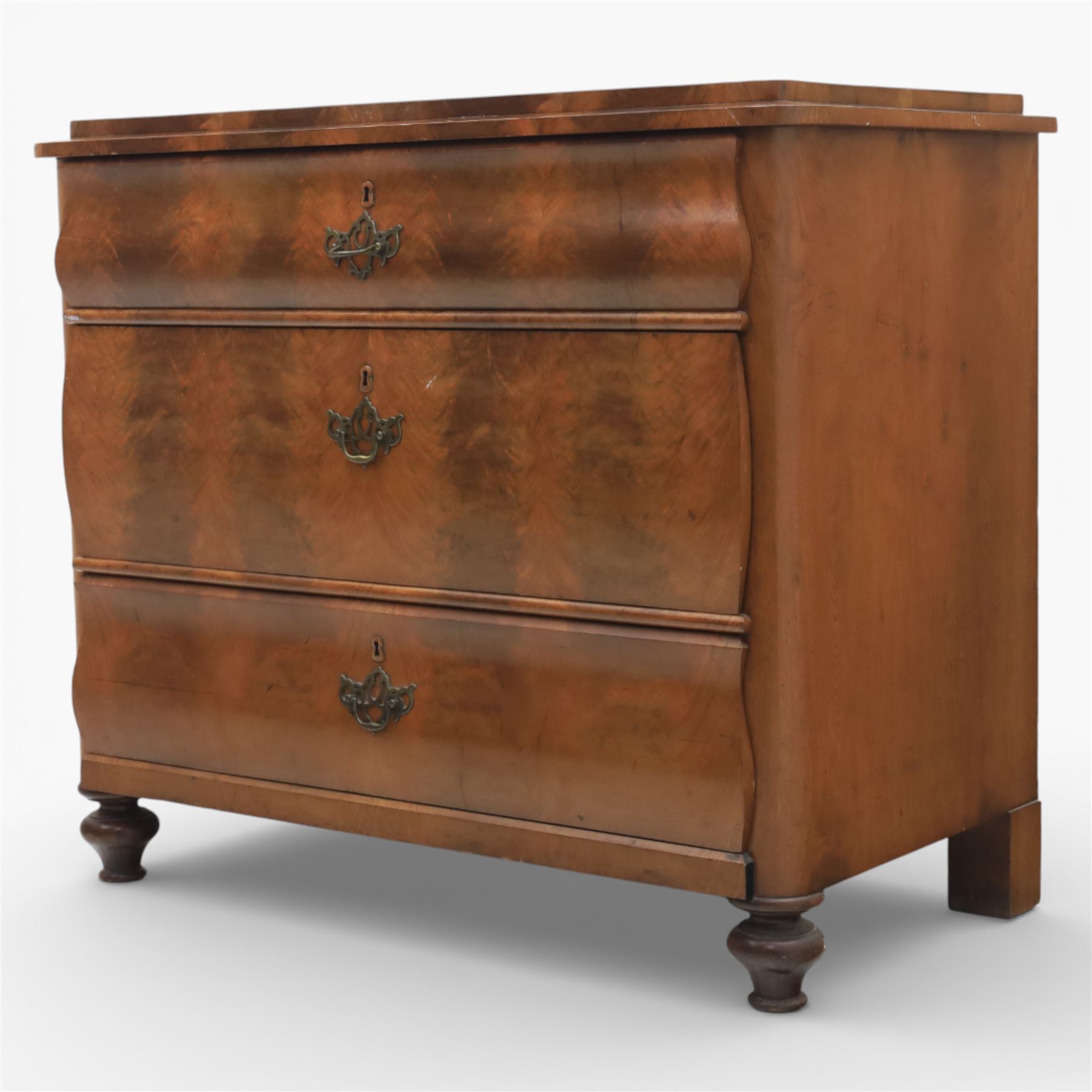 Late Victorian walnut and burr walnut chest of drawers, moulded top with rounded corners, finely figured burr walnut drawer fronts arranged as three long drawers, brass batwing handle plates, the lower section raised on turned bun feet