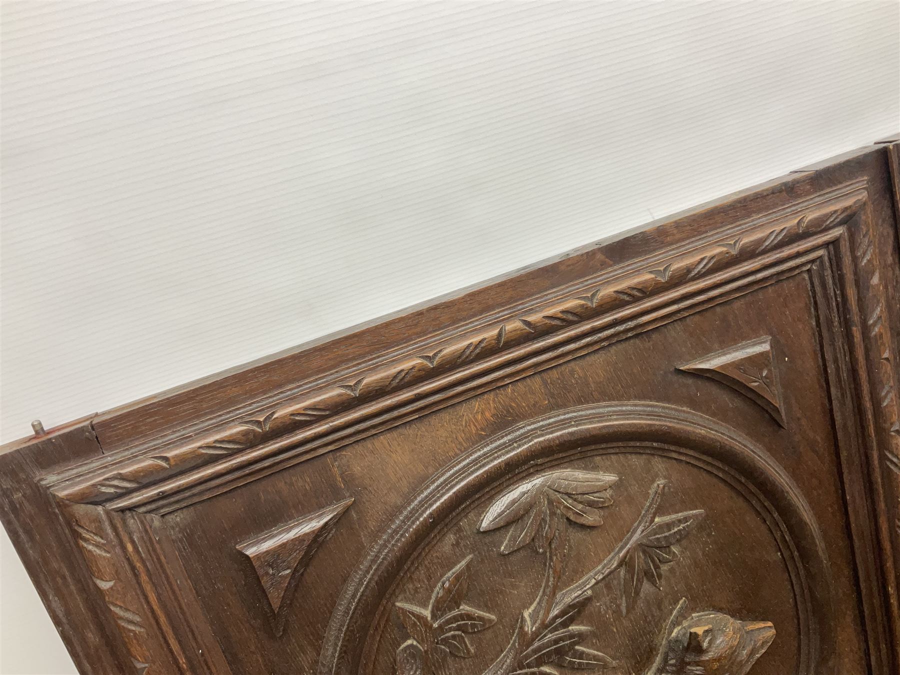 Pair of oak furniture door panels, carved in relief with a fox to one and a hound to the other, together with a pair of smaller oak panels, carved in relief with a hare to one and a grouse to the other, doors W63.cm x H62cm, panels W43cm x H60cm