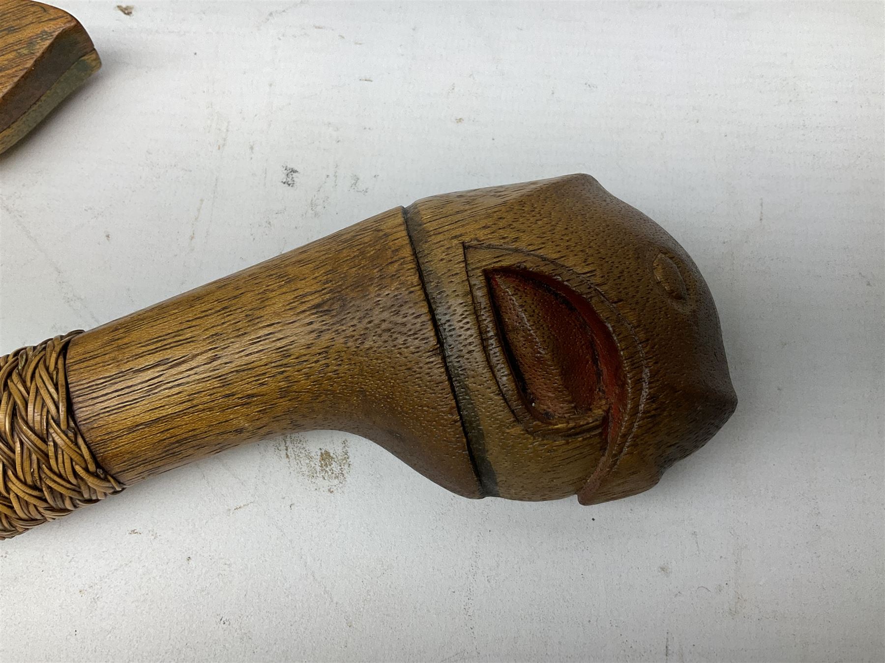Malaysian parang survival knife the 29cm steel blade with character marks, cane bound teak grip carved with a stylised turtle head to the pommel, with matching teak scabbard L46cm overall