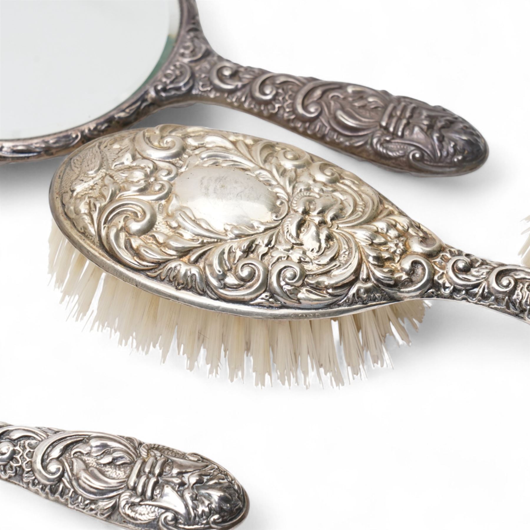 Pair of silver backed hand mirrors, clothes brush and hair brush (4)