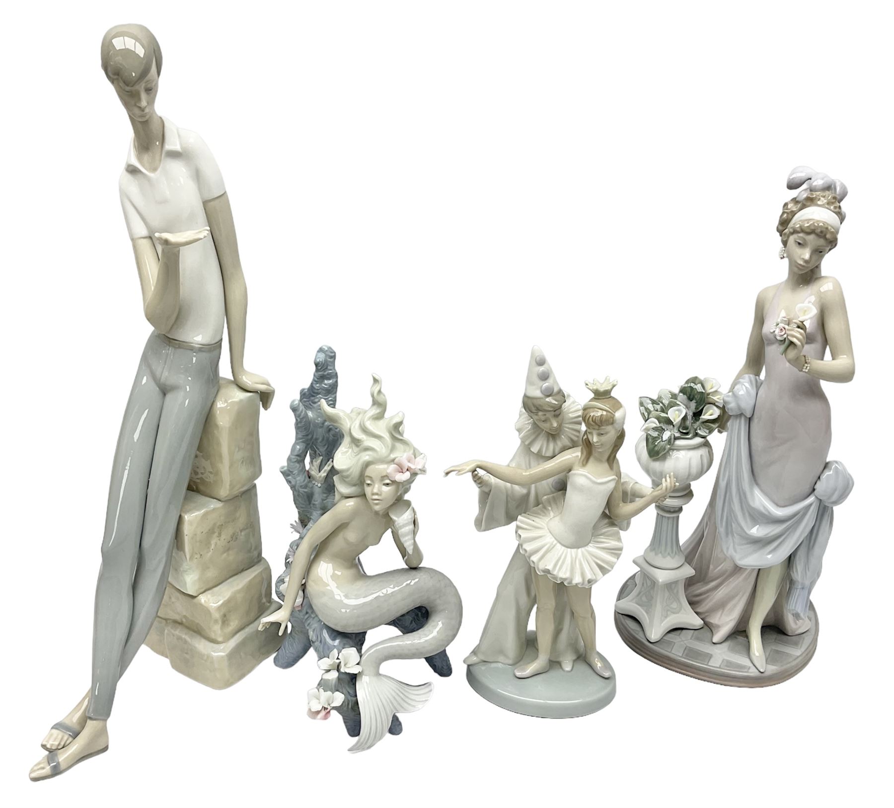 Four Lladro figures, comprising Touch of Class no 5377, Boy Student no 4517, Ocean Beauty no 5785 and Carnival Couple no 4882, largest example H45cm