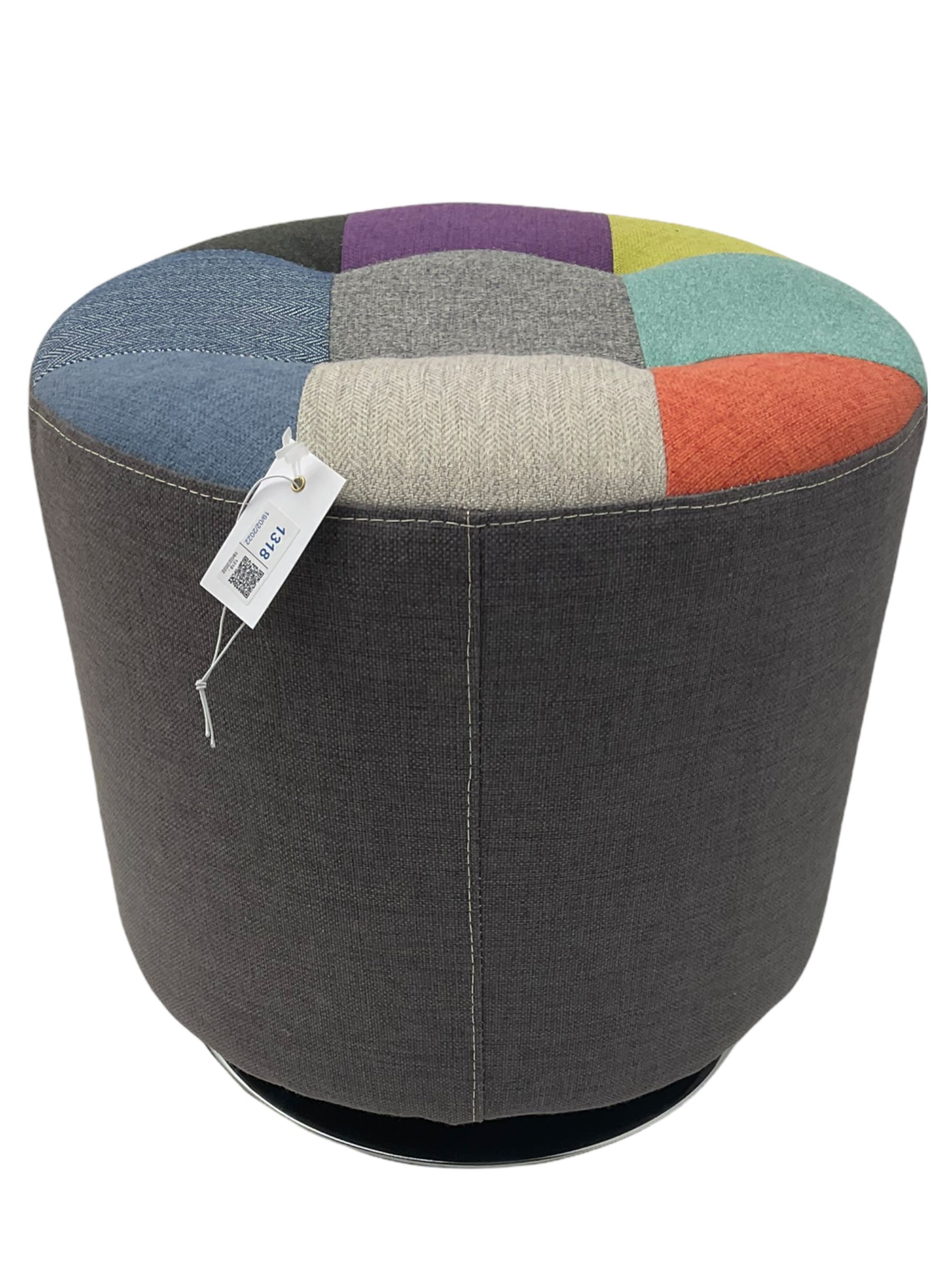 Circular revolving pouffe footstool, upholstered in grey with multi