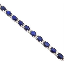 18ct white gold sapphire and diamond bracelet, twenty-six oval cut sapphires, each spaced by two round brilliant cut diamonds, stamped 750, total sapphire weight 10.60 carat, total diamond weight 0.46 carat