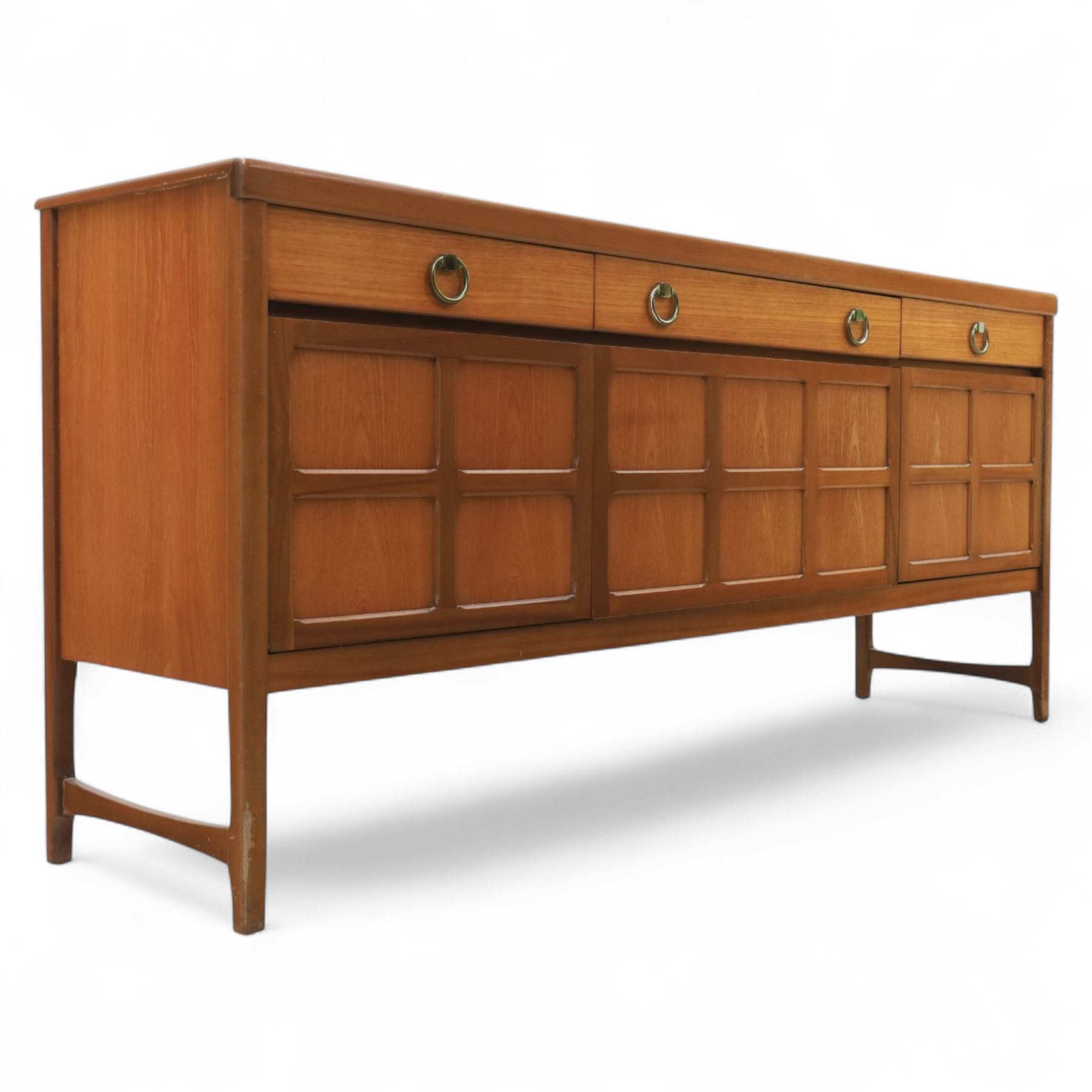 Nathan - mid 20th century teak sideboard, fitted with three drawers with brass ring handles, above a central fall front cabinet, flanked by two cupboard doors, raised on square tapering supports