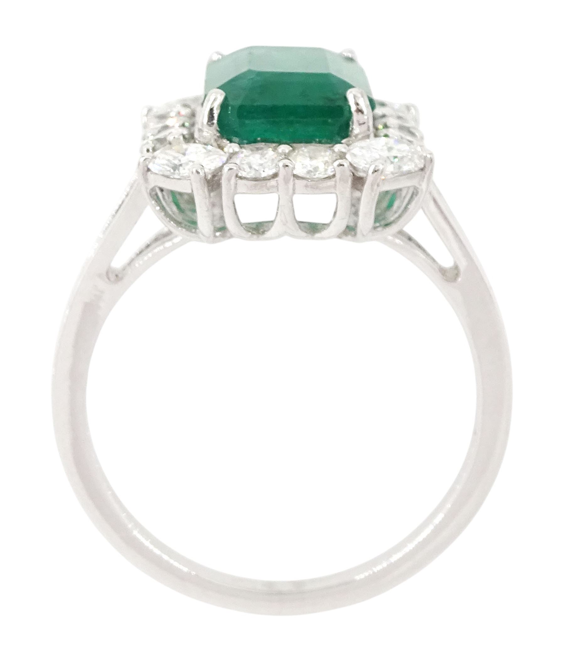18ct white gold emerald and diamond cluster ring, single octagonal cut emerald of approx 2.90 carat, surrounded by twelve round brilliant cut diamonds and four oval cut diamonds to each corner, stamped 18K, total diamond weight approx 0.90 carat