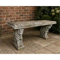 Weathered cast stone three piece garden bench, slab top raised on mythical creature supports