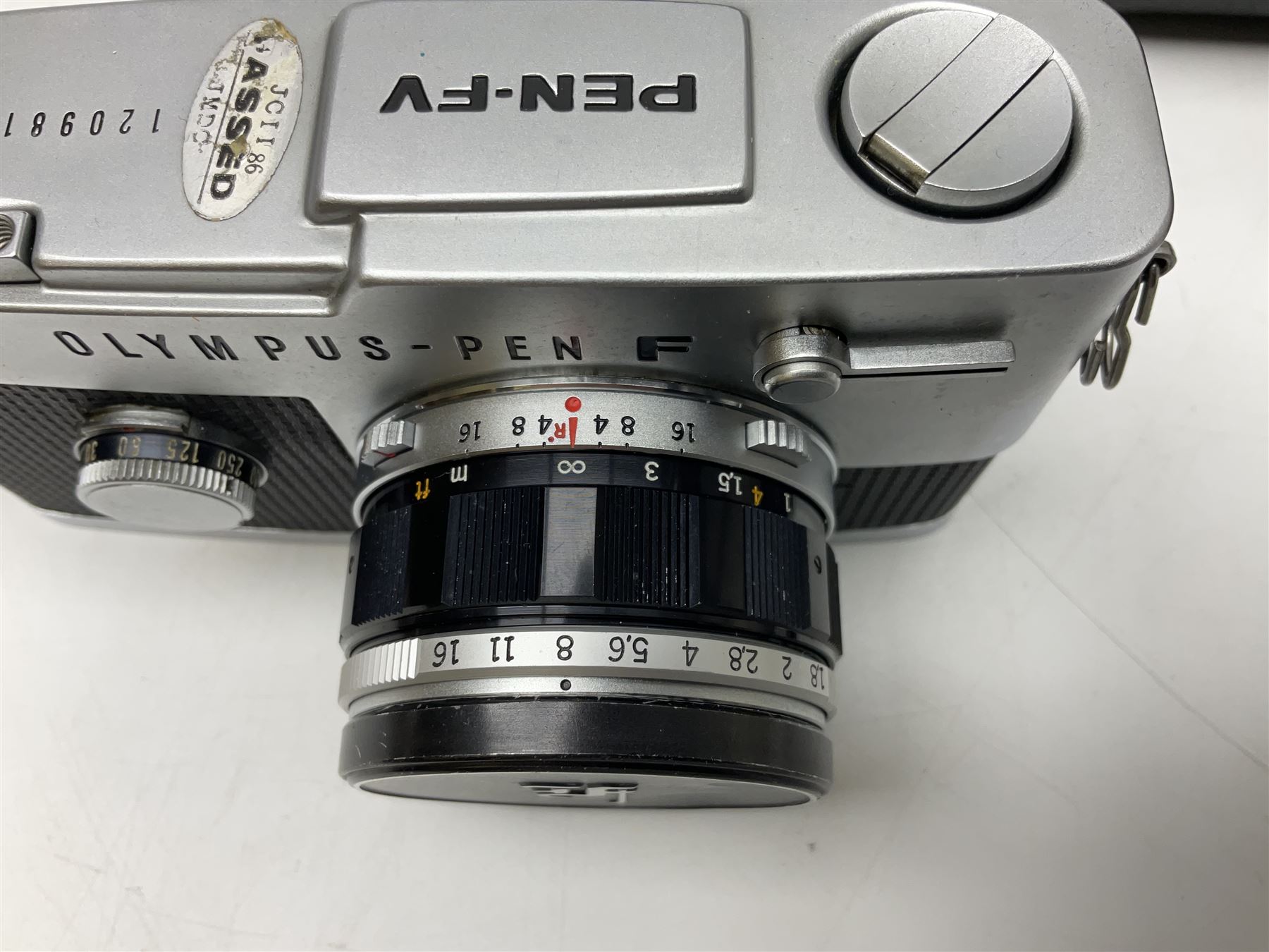 Olympus Pen FV camera body, serial no. 120981, with 'Olympus F.Zuiko Auto-S 1:1.8 f=38mm' lens, serial no. 251523, 'Olympus Zuiko Auto-zoom1:3.5 f=50-90mm, serial no. 135752 and clip on shoe