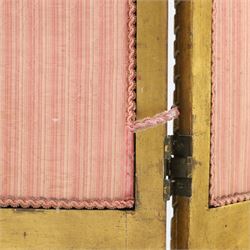 Early 20th century gilt and bevelled mirrored four panel folding screen, with two mirrors per side, flanked by beaded edges and scrolled finials, arcaded carved frieze