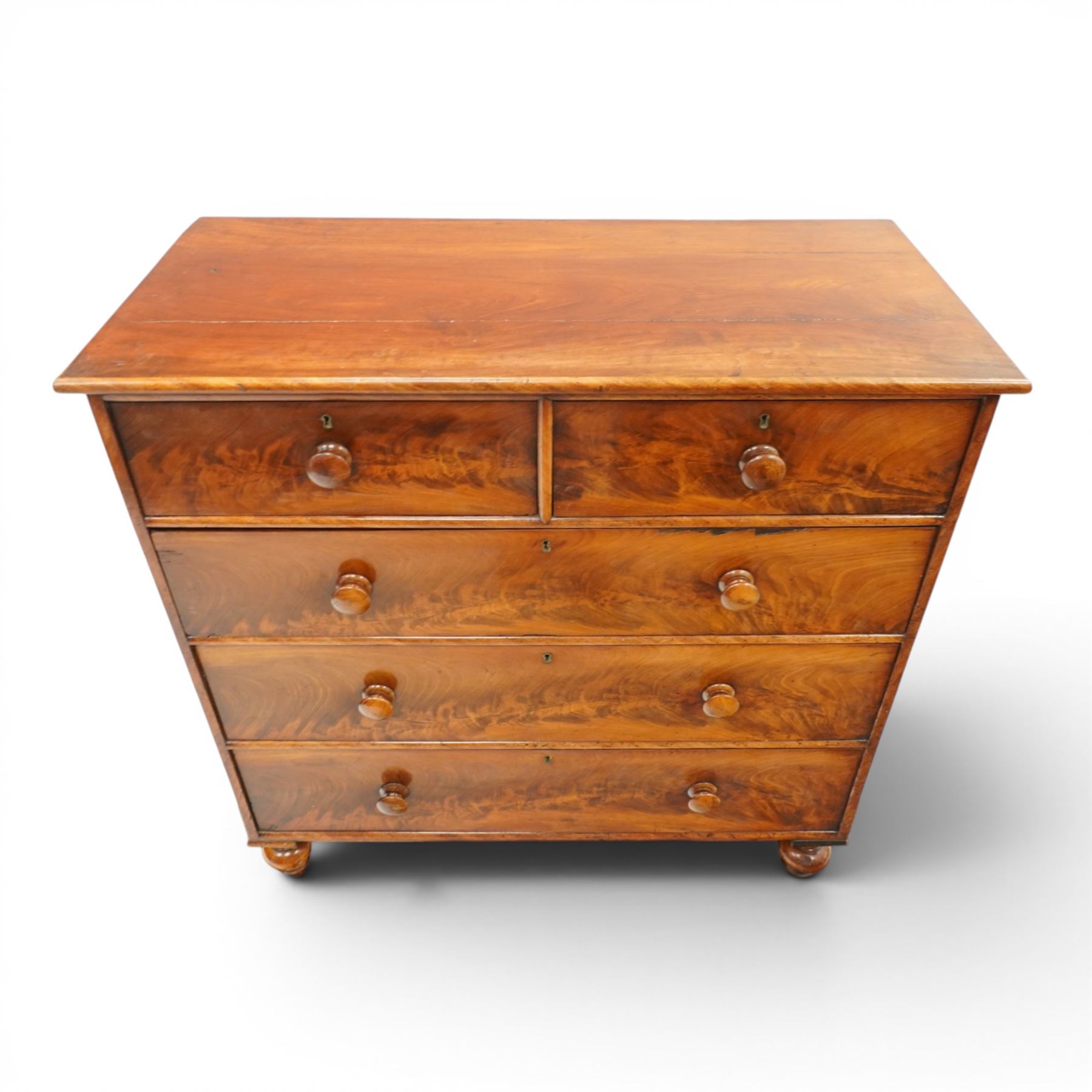 Mid-Victorian figured mahogany chest of drawers, circa 1860, rectangular moulded top over two short and three long drawers with figured veneers, on turned supports