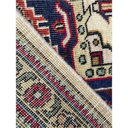 Persian Heriz pale wheat ground rug, indigo pole medallion surrounded by neatly arranged Hac and stylised flower head motifs, indigo main border decorated with alternating palmette motifs, within floral pattern guard stripes 