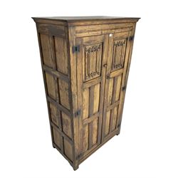 Mid-to-late 20th century oak double wardrobe, enclosed by panelled doors with linenfold decoration