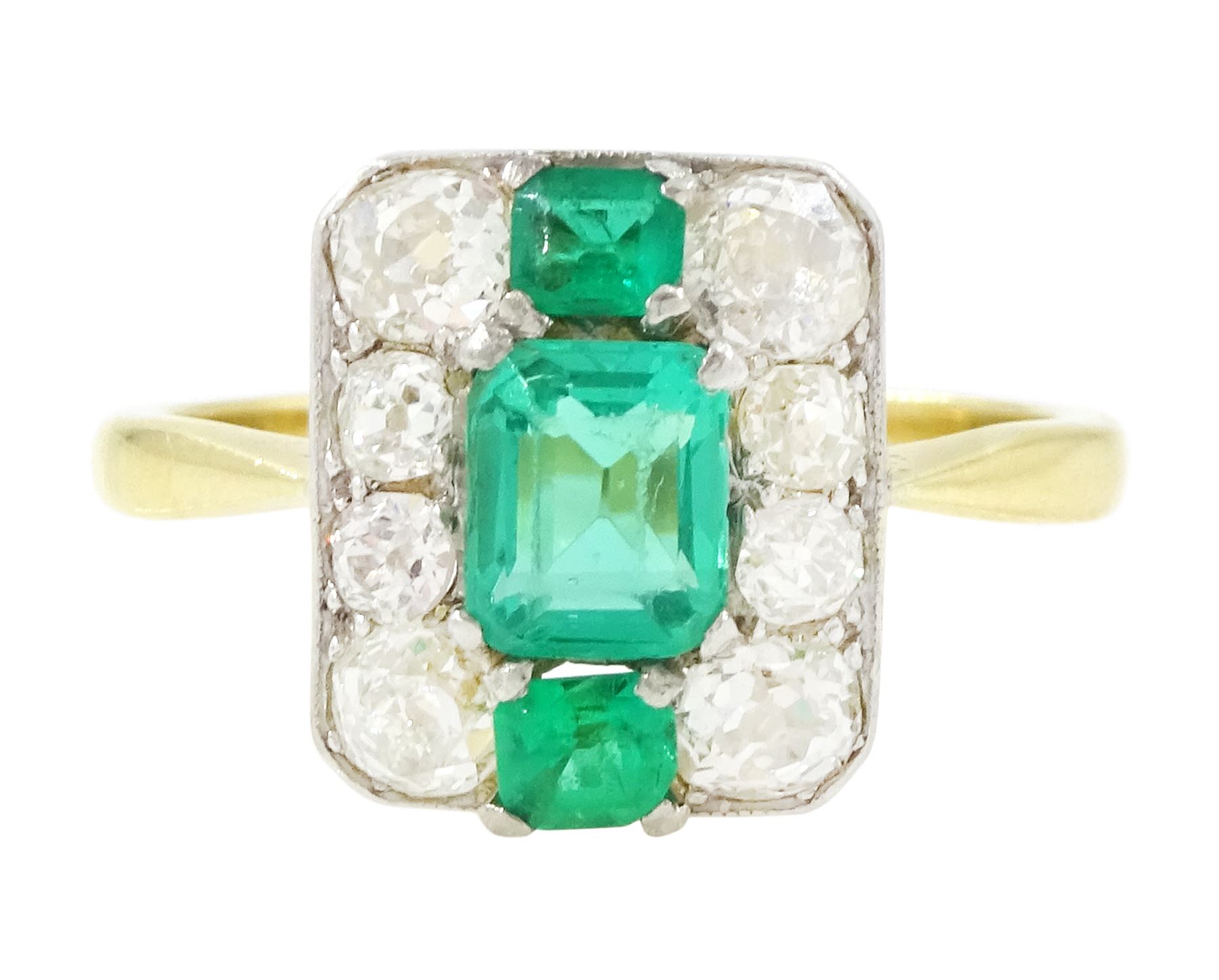 Early 20th century gold emerald and diamond panel ring, three octagonal cut emeralds, with four old cut diamonds set either side, stamped 18ct Plat, total diamond weight approx 0.85 carat