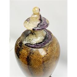 Early 19th century and later Blue John urn, Winnats one vein, of ovoid form with integrated cover and ball finial, upon a spreading circular base, and square stepped black lacquered base, H34.5cm