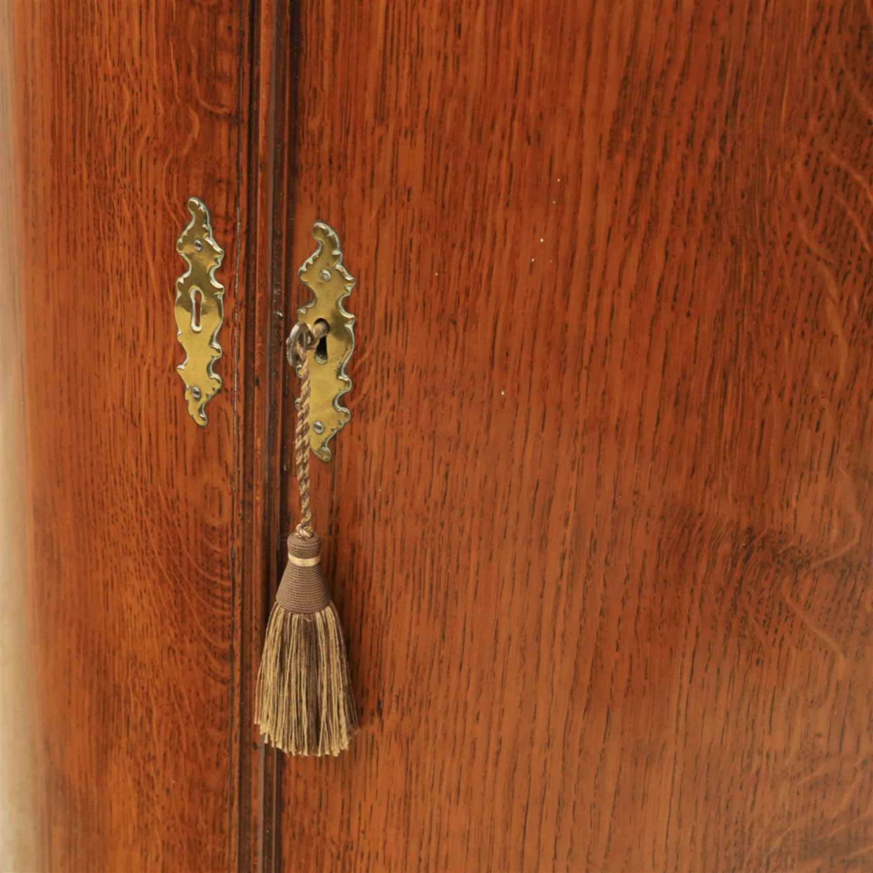 George III oak and mahogany wall hanging cylinder corner cupboard, moulded cavetto cornice over double cupboard enclosing three shelves