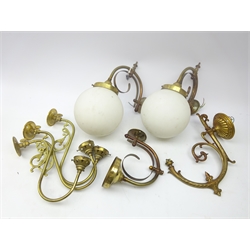  Three brass scroll wall lights, two with globular opaque glass shades, together with four other scroll brass wall lights (7)  
