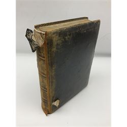  Victorian leather bound photo album, the interior leaves containing apertures of various sizes and shapes of portraits surrounded by printed floral designs, with brass clasp and painted gold decoration to edges, H30cm