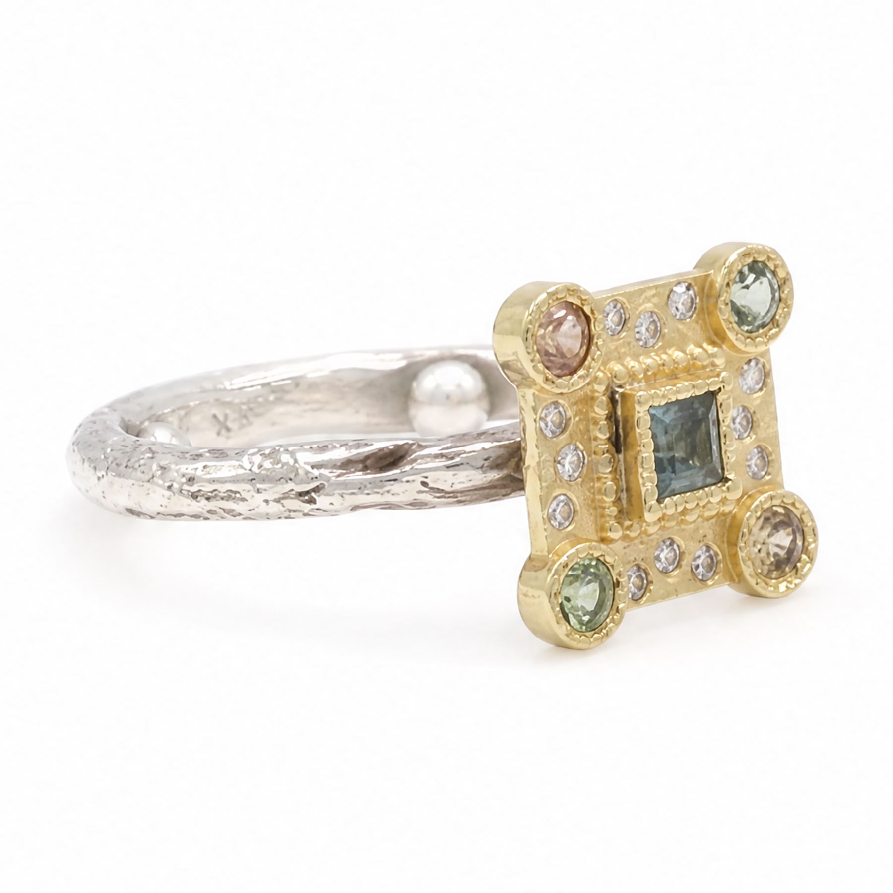 18ct gold and silver blue topaz, sapphire diamond dress ring, square cut blue topaz, surrounded by round brilliant cut diamonds, the corners set with green and orange / brown sapphires,stamped 18K 925