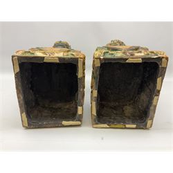Pair of Chinese Temple Lions or Dogs of Foo, modelled in seated post, one with one front paw resting upon a ball, the other upon a cub, each upon stylised plinth base, H44cm