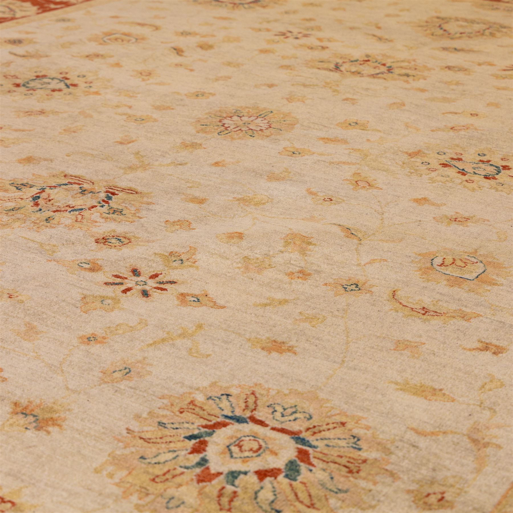 Indo-Persian Ziegler style Farahan design hand-knotted wool carpet, ivory field with open composition with dispersed palmettes, floral sprays and scrolling vinery with central subtle medallion enclosed within deep madder red border of complementary stylized foliate motifs